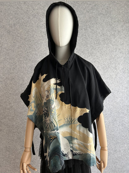 Black hooded kimono poncho with white cranes and teal waves, front view