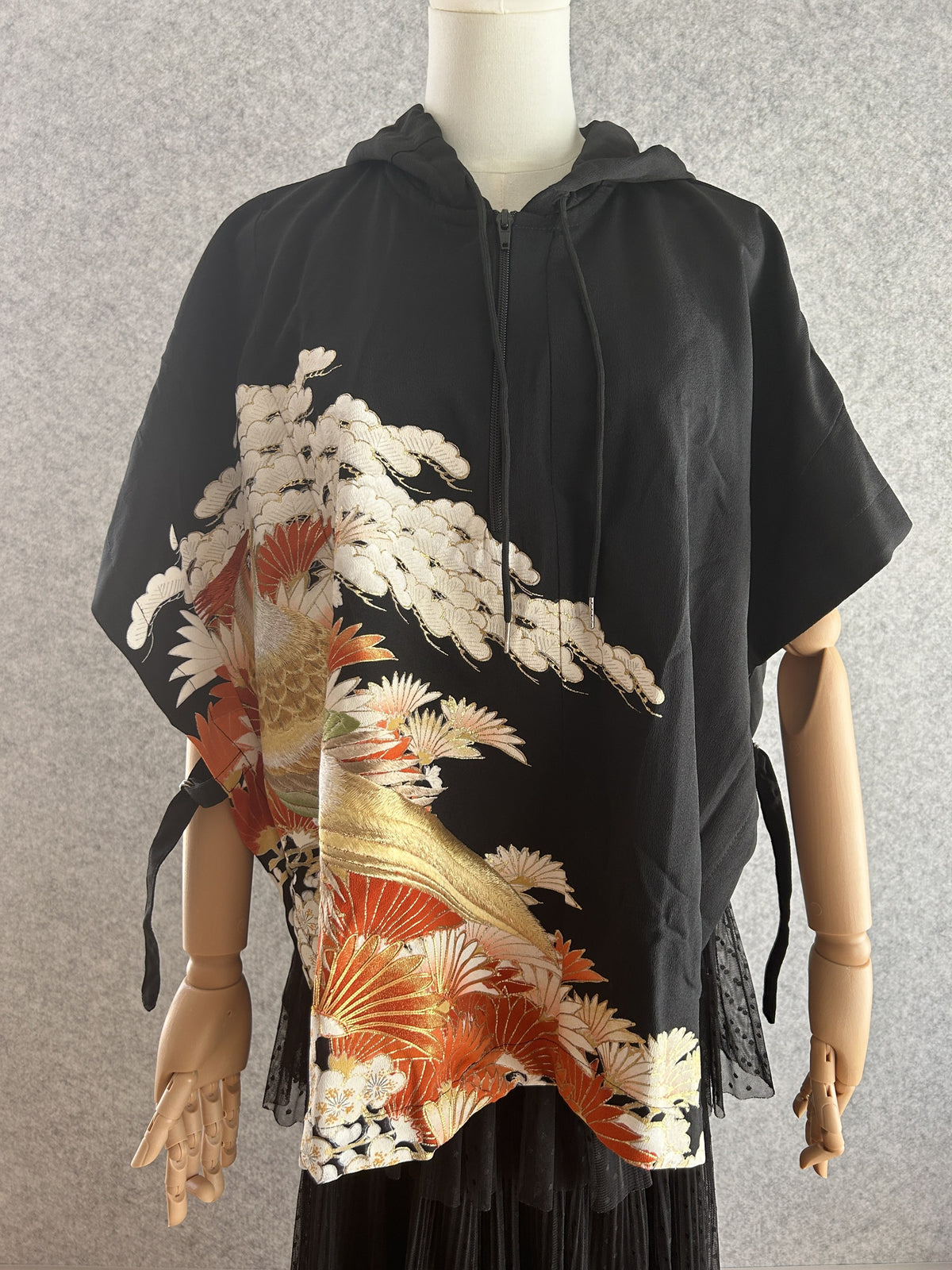 Black hooded kimono poncho with bird, white pine and orange leaves, front view
