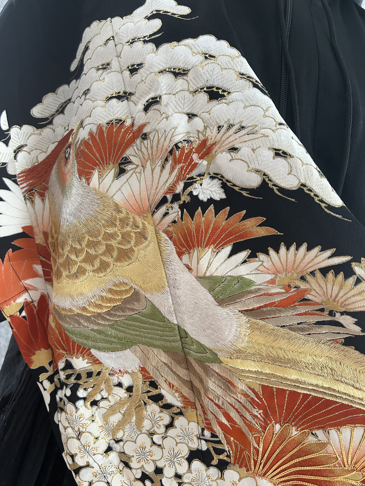 Detail of bird with white pine, orange leaves and white plum blossoms
