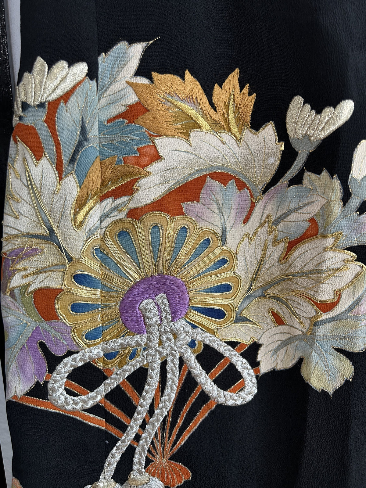 Black kimono skirt with fan, flower and silver cord motif, detail