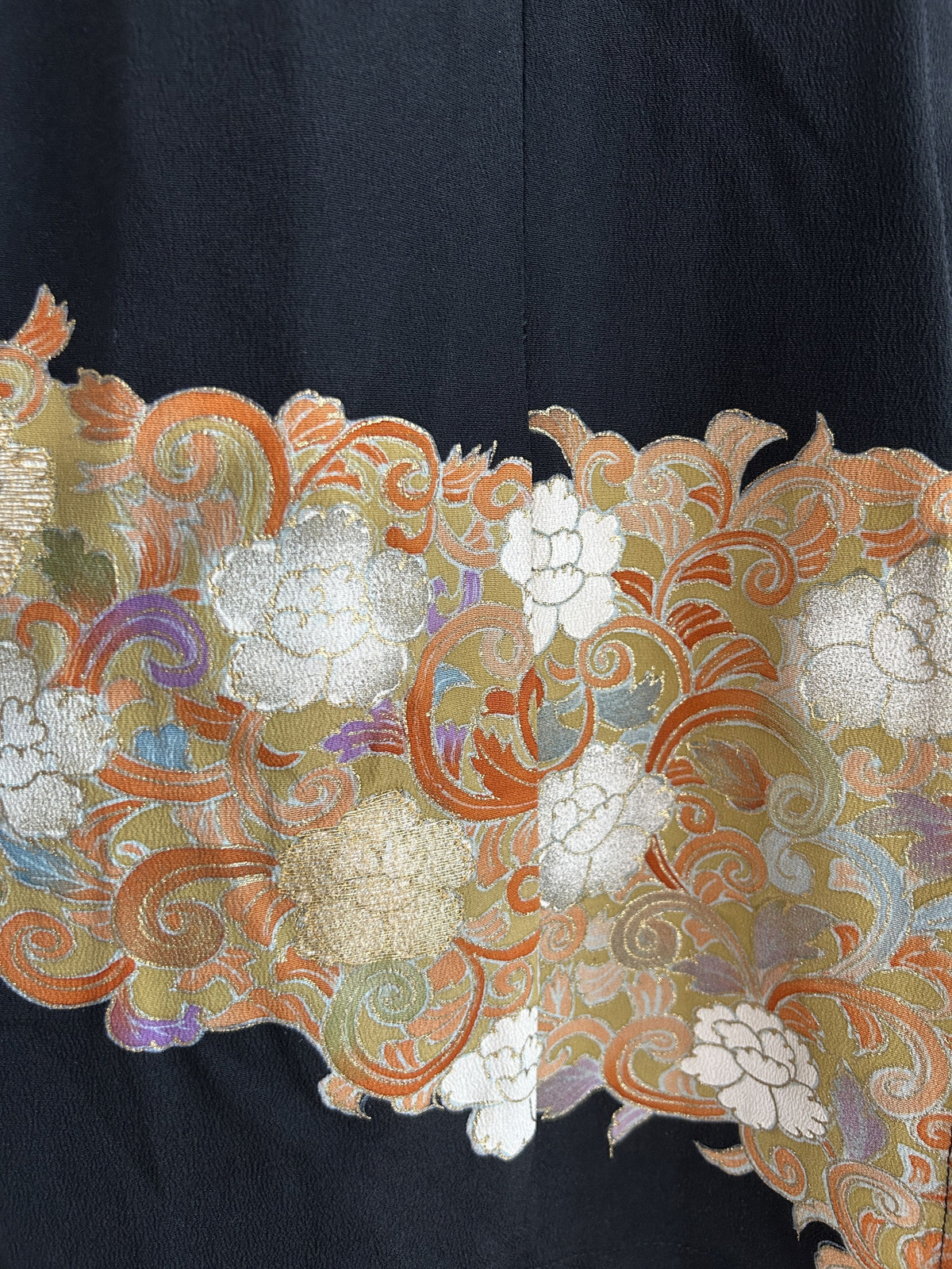 Band of white and gold flowers on orange swirls, skirt detail