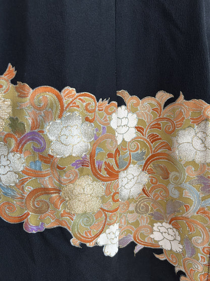 Band of white and gold flowers on orange swirls, skirt detail