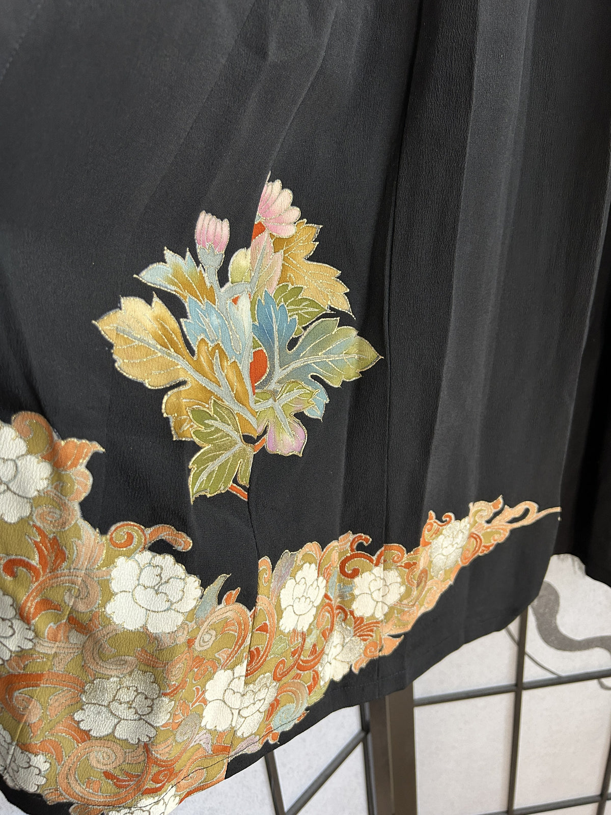 Black kimono skirt with leaf motif and floral band near hem