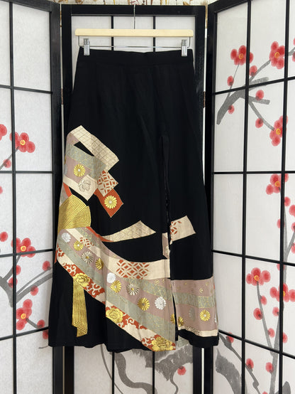 Black high slit kimono skirt with ribbon bands and gold flowers, front view