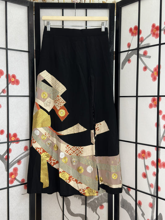 Black high slit kimono skirt with ribbon bands and gold flowers, front view