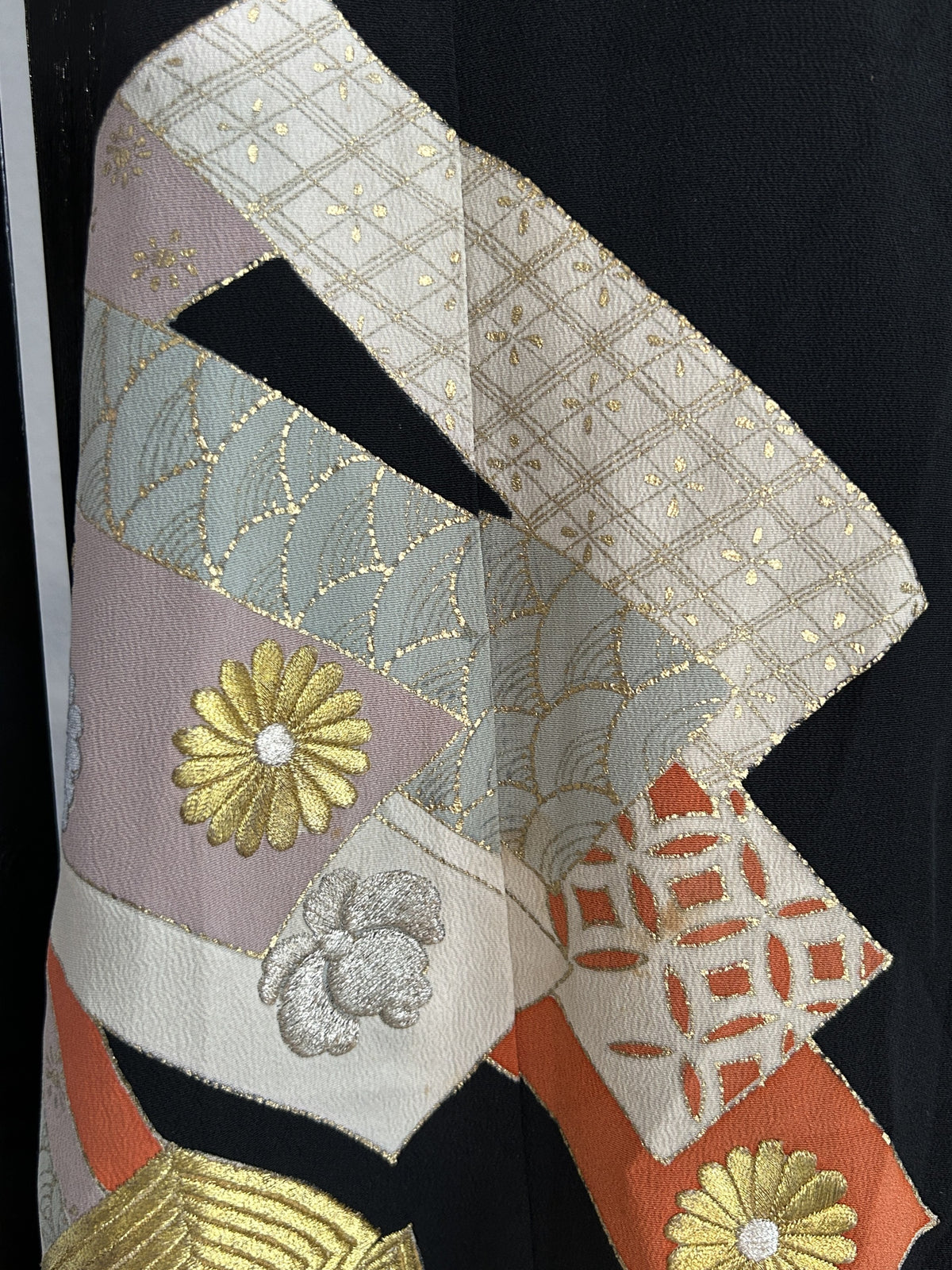 Cream, grey and orange ribbon bands with gold flower on black skirt