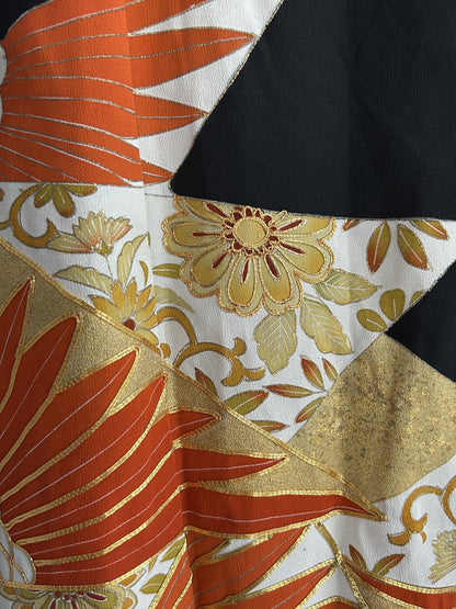 Orange leaves, gold bands and golden flowers on black kimono skirt