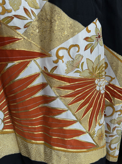 Orange spiky leaf motif with gold wave band on kimono skirt