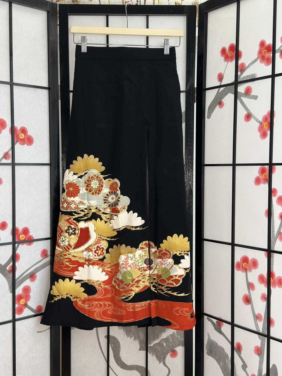 Black high slit kimono skirt with red and gold design, front view