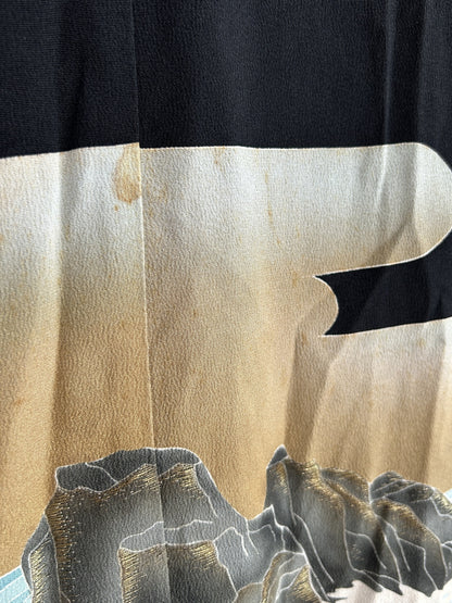 Beige and cream sky above grey rocks on black kimono skirt