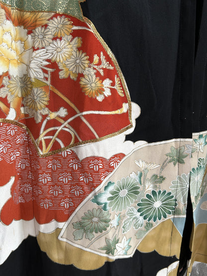 Red and cream fans with green flowers on black kimono skirt, detail