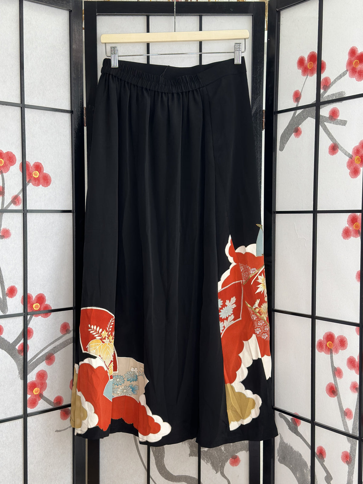 Black kimono skirt with elastic waistband and red fan design, back view