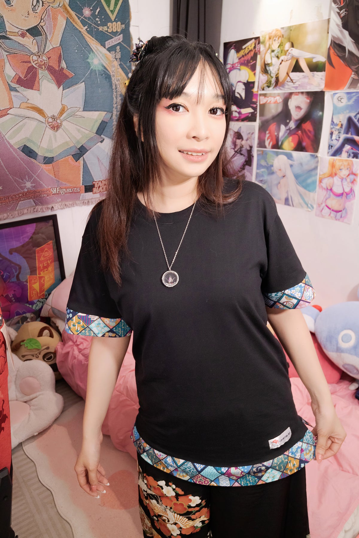 Model wearing the black unisex t-shirt regular fit with traditional Japanese fabric trim