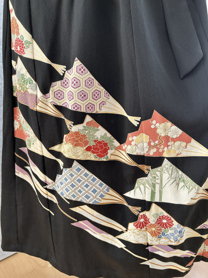 Black kimono dress skirt with colourful fan-shaped floral motifs near the hem