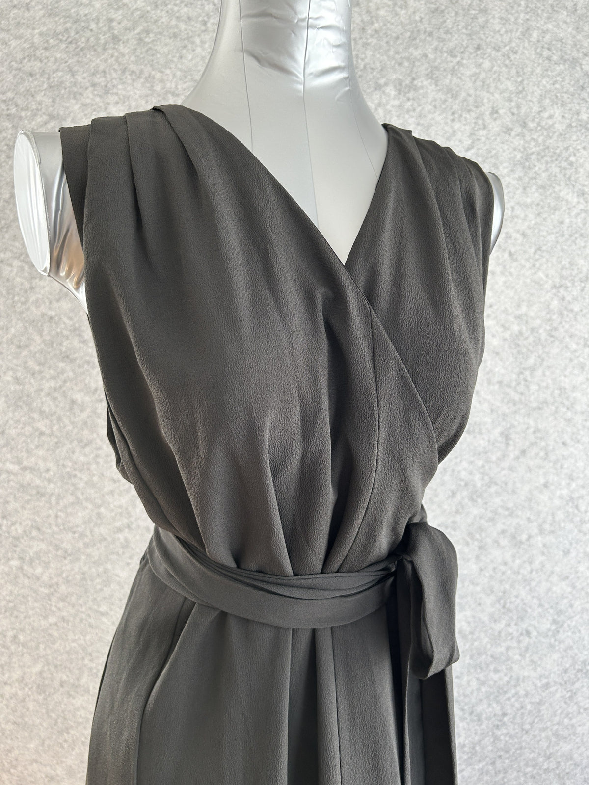 Black sleeveless kimono wrap dress with tie belt, upper body front view