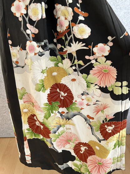 Black kimono dress skirt with large chrysanthemum and blossom design, side view