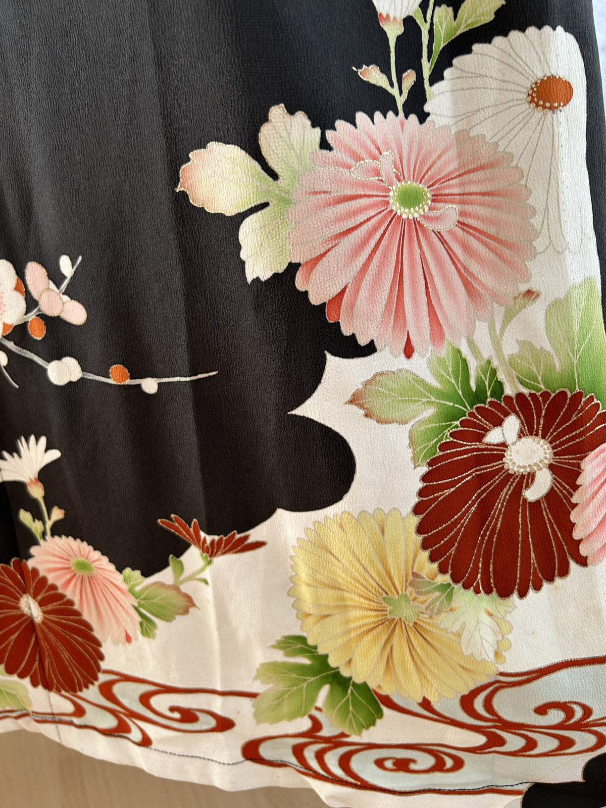 Black kimono dress, detail of pink chrysanthemum and red swirl hem border