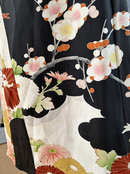 Black kimono dress, detail of pink and white blossom branch on skirt