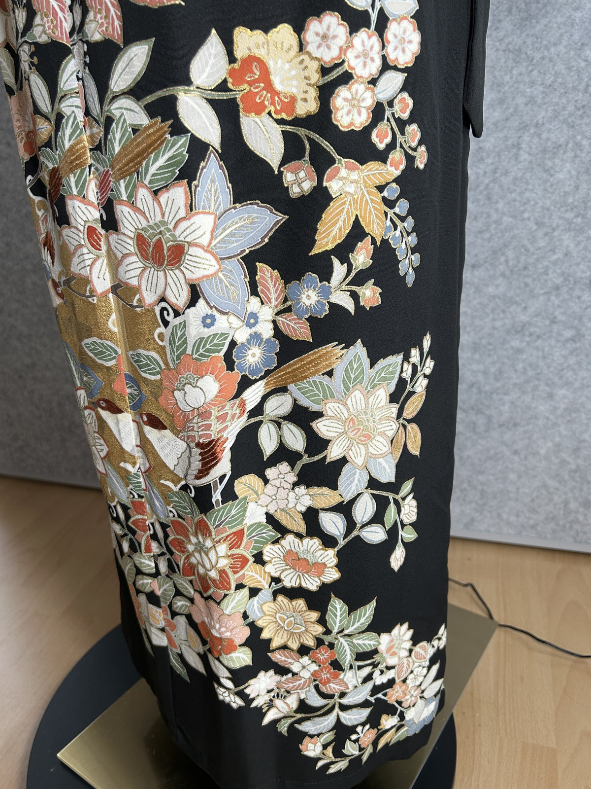 Black kimono dress, detail of coral and cream flowers with gold panels
