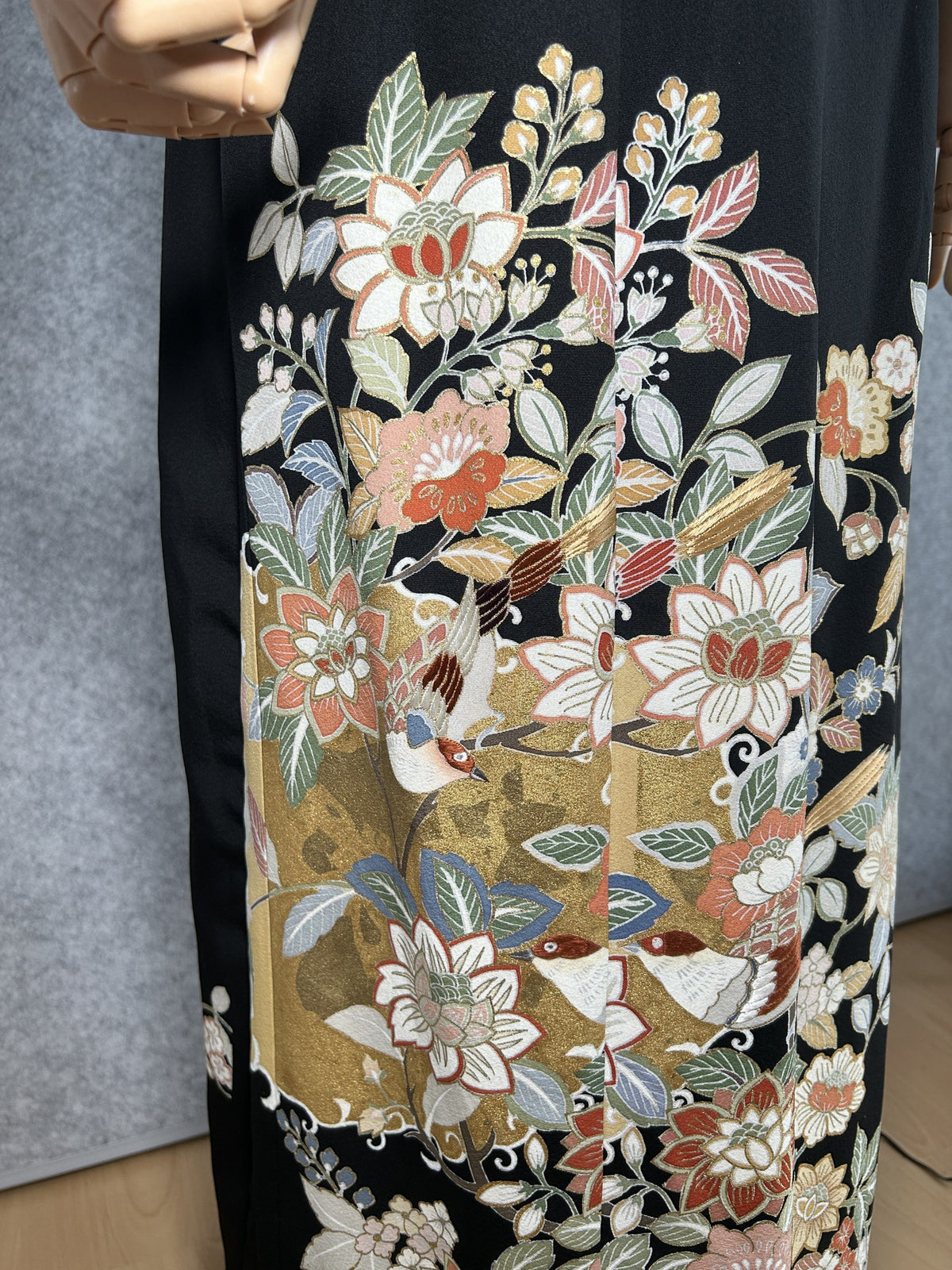Black kimono dress, close-up of flowers and small birds on the skirt
