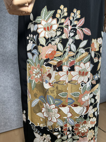 Black kimono dress, close-up of flowers and small birds on the skirt