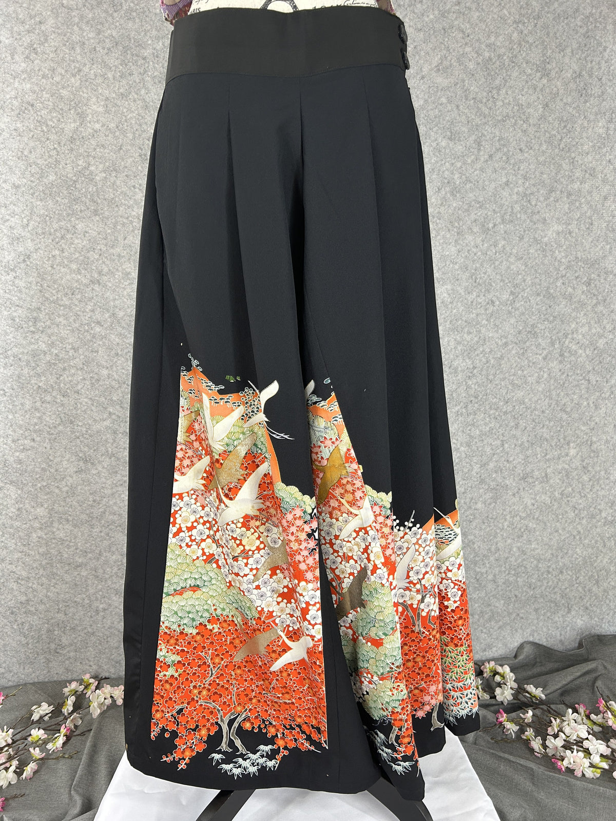 Black upcycled kimono palazzo pants with white cranes over orange-red blossoms, front view
