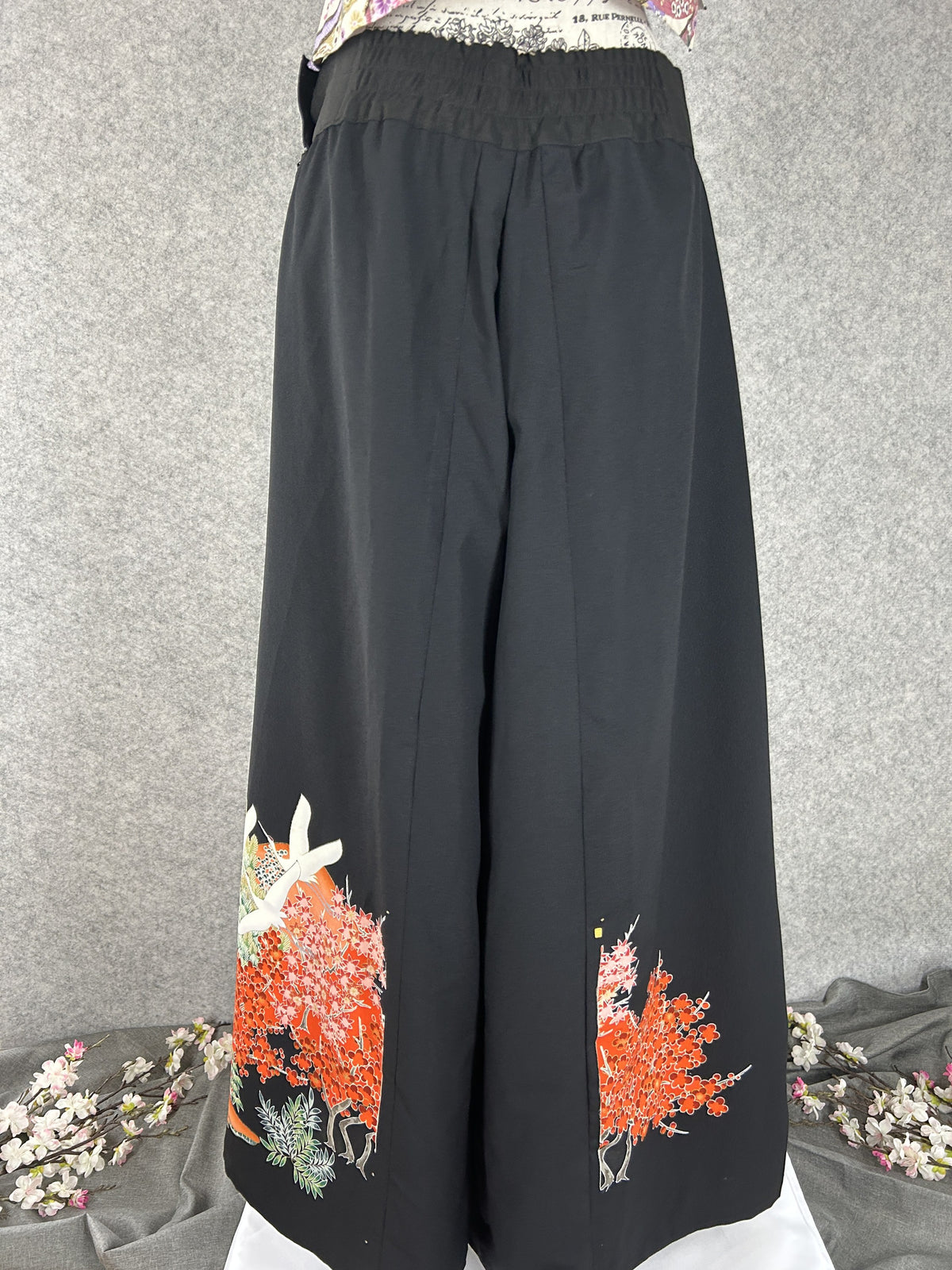 Black upcycled kimono palazzo pants with cranes and red maple at the hem, back view