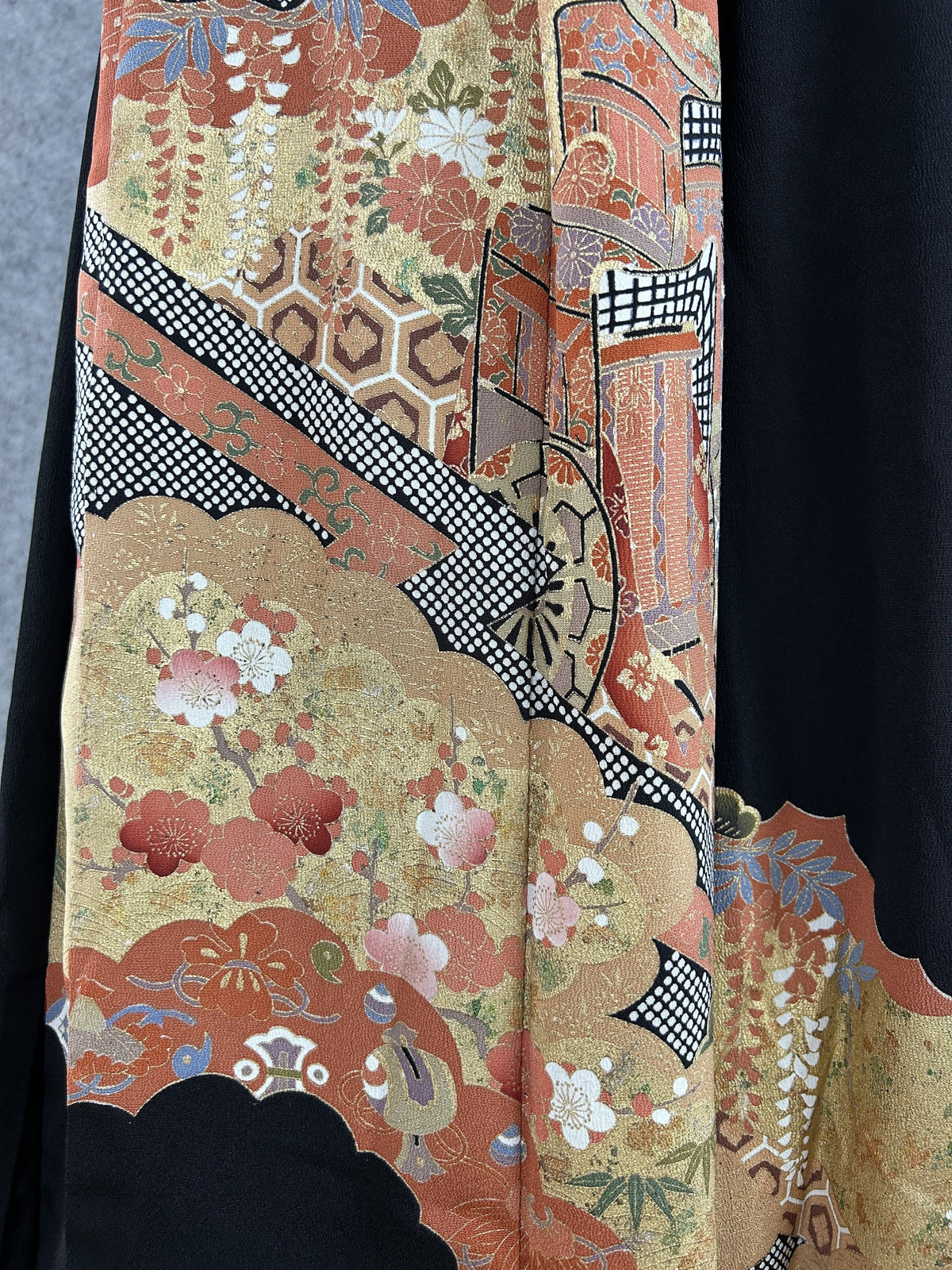 Black upcycled kimono palazzo pants, detail of the side with rust and gold cloud panels