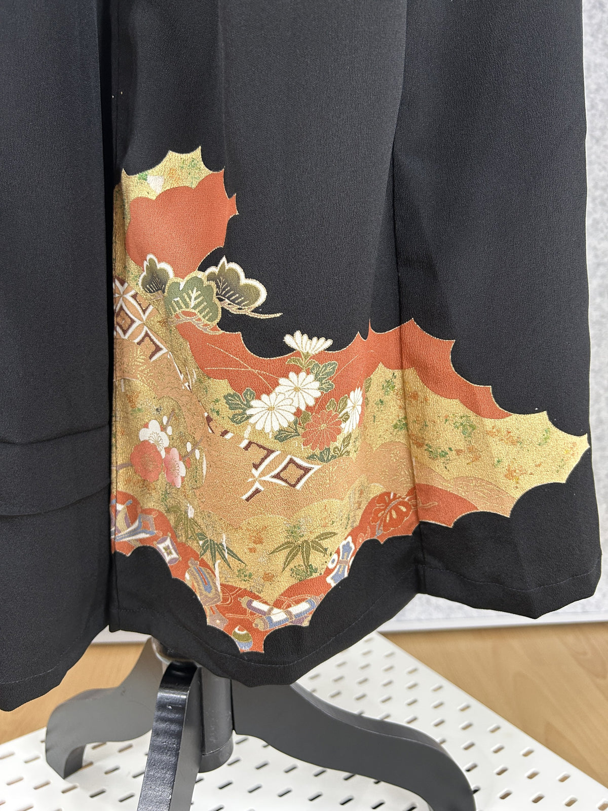 Black upcycled kimono palazzo pants, detail of the hem with pine and chrysanthemums on gold