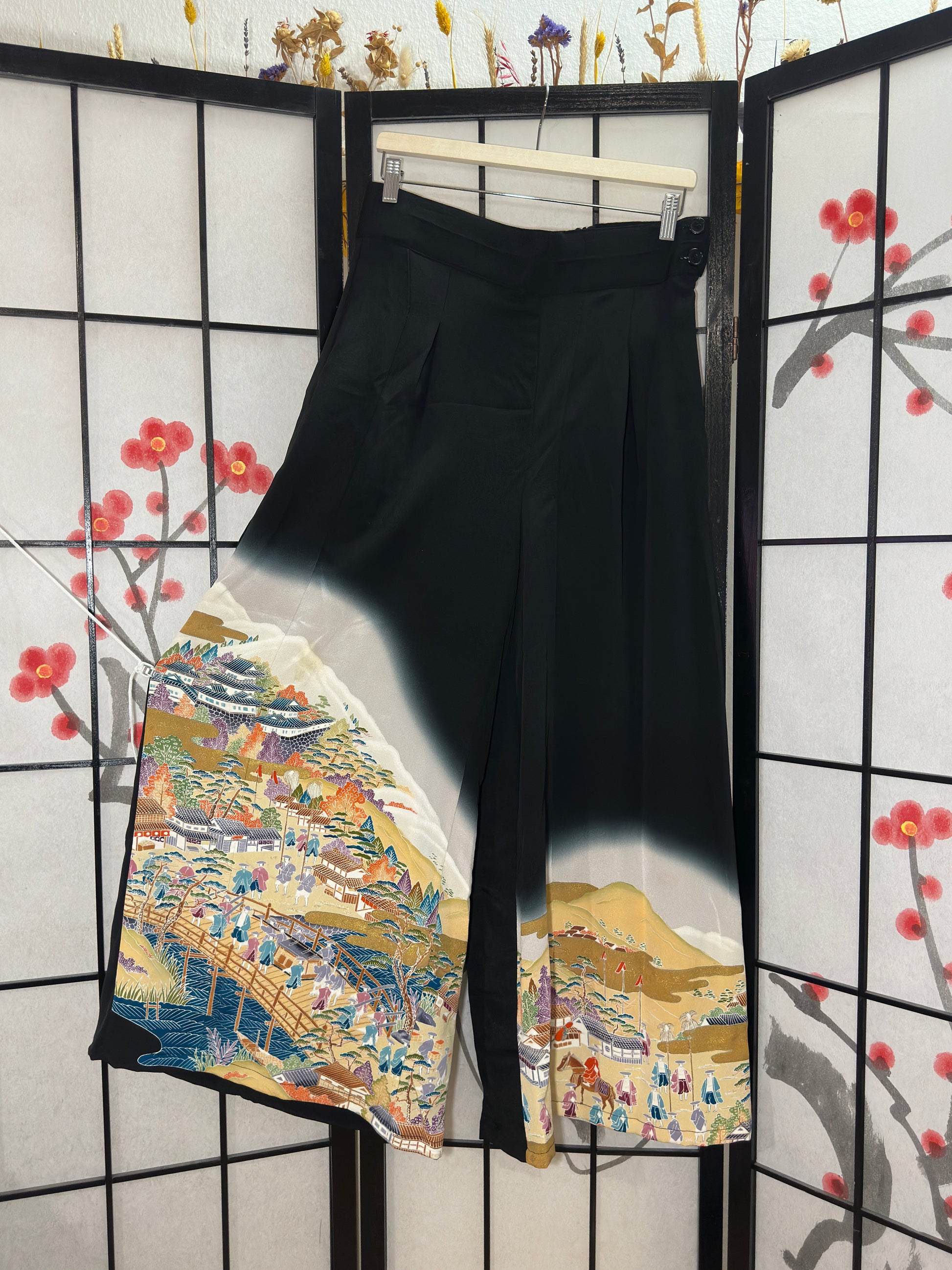 Black traditional garment with colorful embroidery on a black and white checkered background