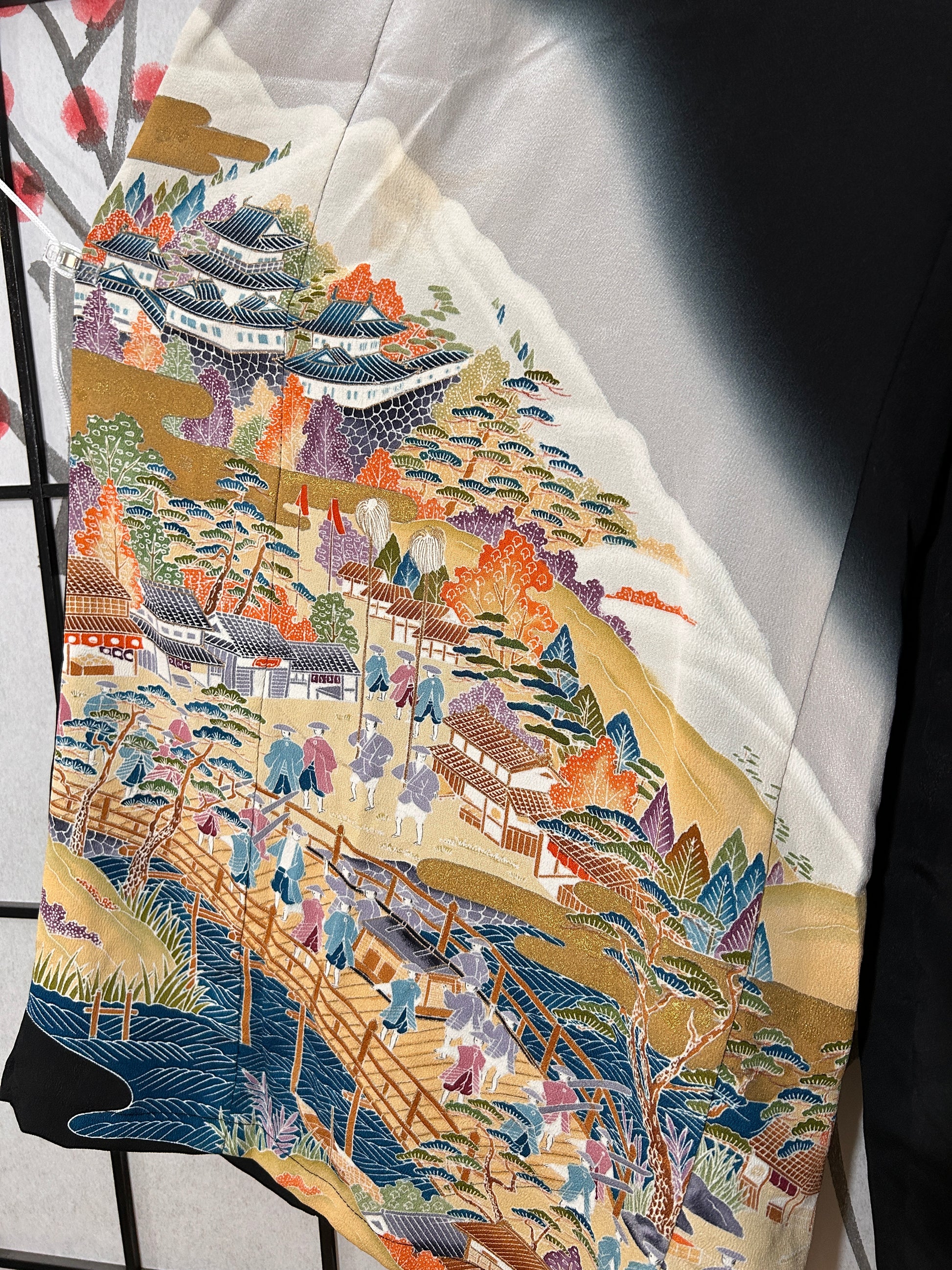 Colorful tapestry with a landscape design on a white surface