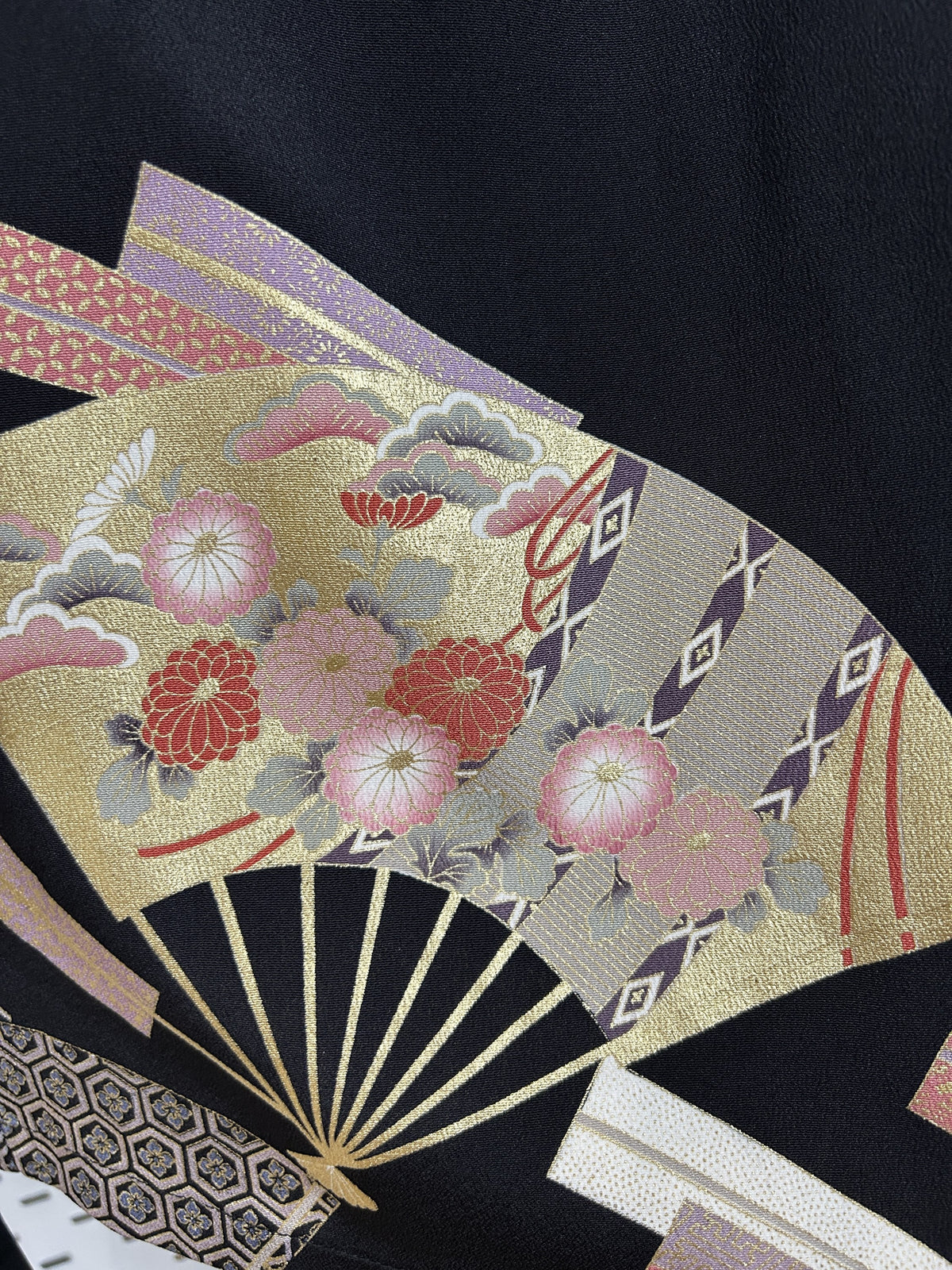 Black upcycled kimono palazzo pants, close-up of a gold fan with pink chrysanthemums and pine