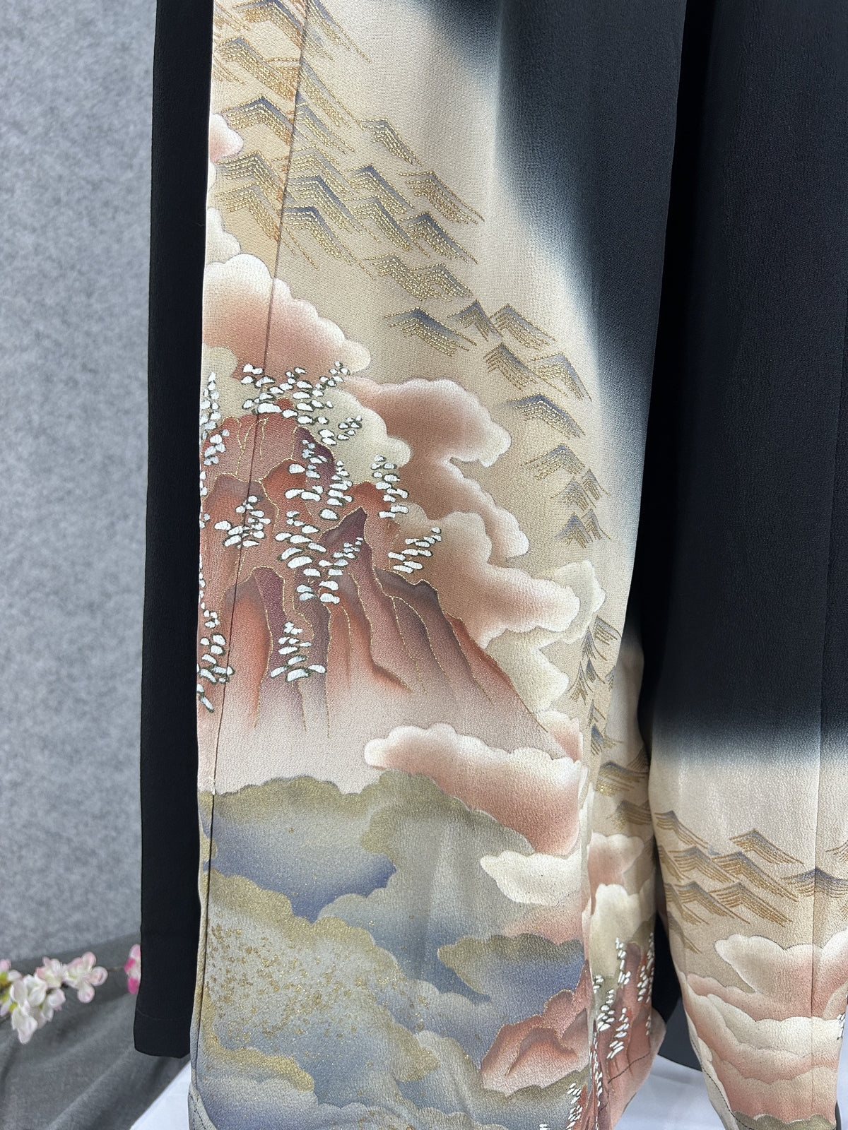Black upcycled kimono palazzo pants, detail of pink clouds, hills and rooftops on the hem