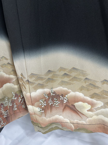 Black upcycled kimono palazzo pants, detail of the hem with clouds, hills and gold rooftops