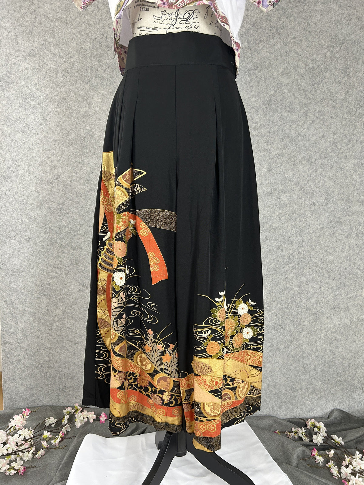 Black upcycled kimono palazzo pants with gold and orange bands and chrysanthemums, front view