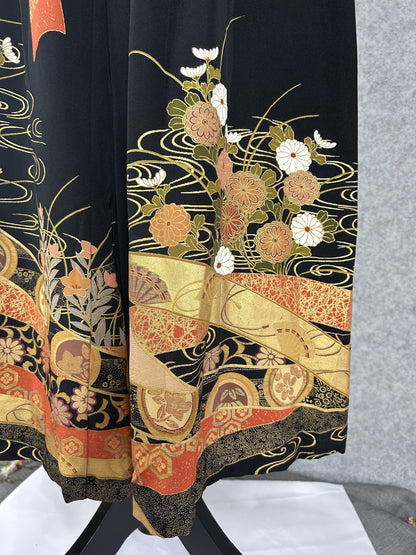 Black upcycled kimono palazzo pants, detail of the hem with white and orange chrysanthemums