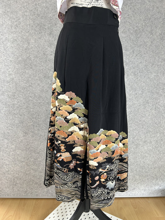 Black upcycled kimono palazzo pants with olive and rust tree clusters and cream waves, front view
