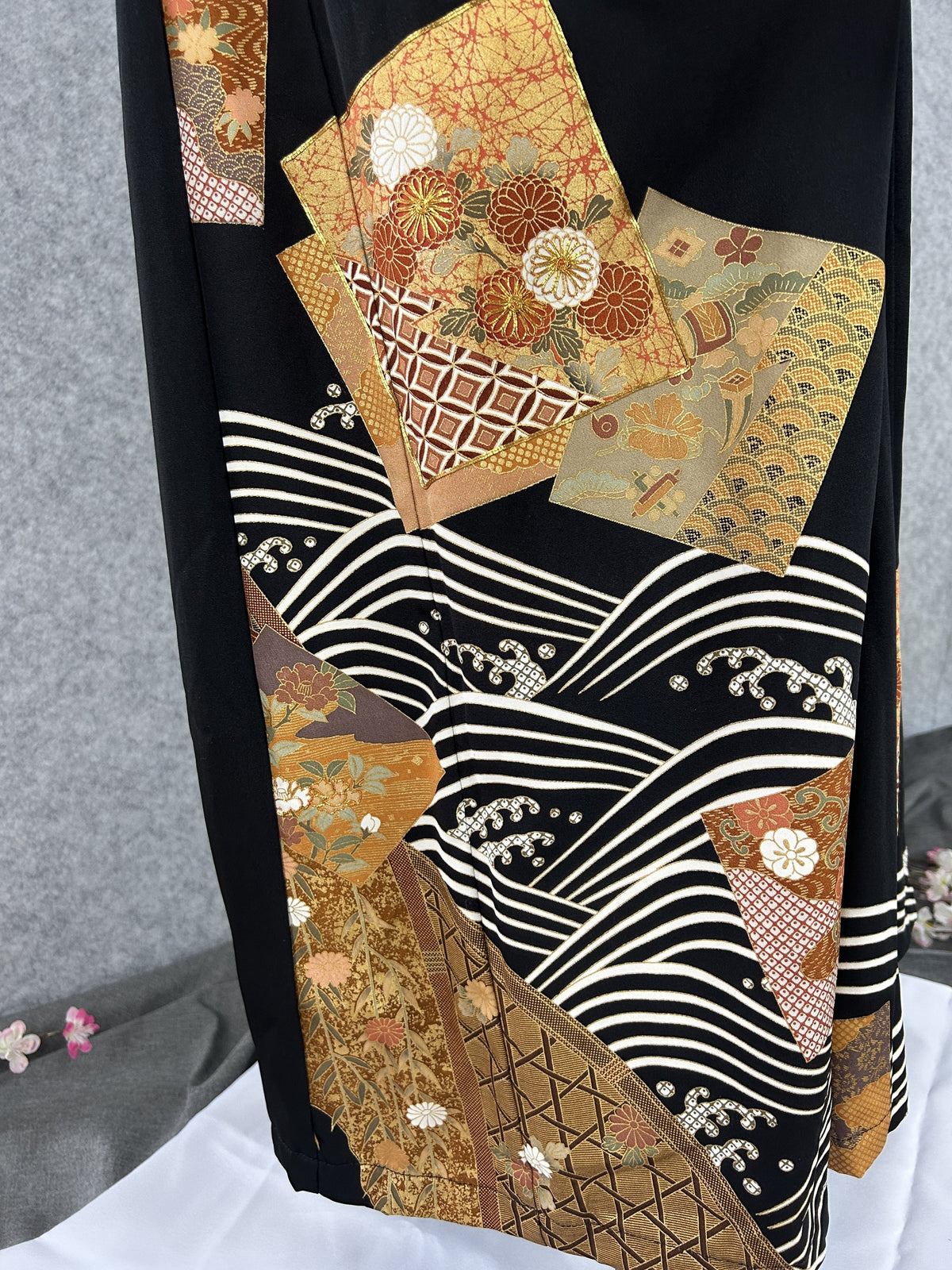 Black upcycled kimono palazzo pants, detail of cream wave lines and gold-rust panels