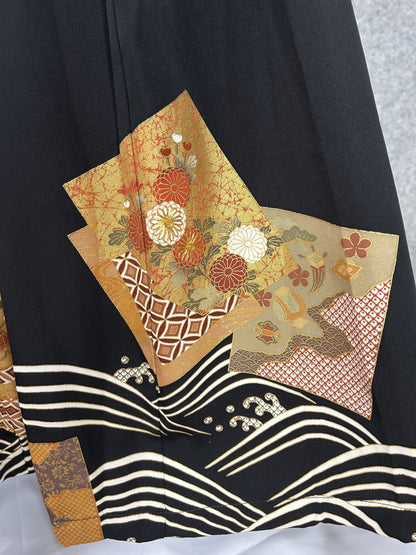Black upcycled kimono palazzo pants, detail of the hem with chrysanthemum panels and waves