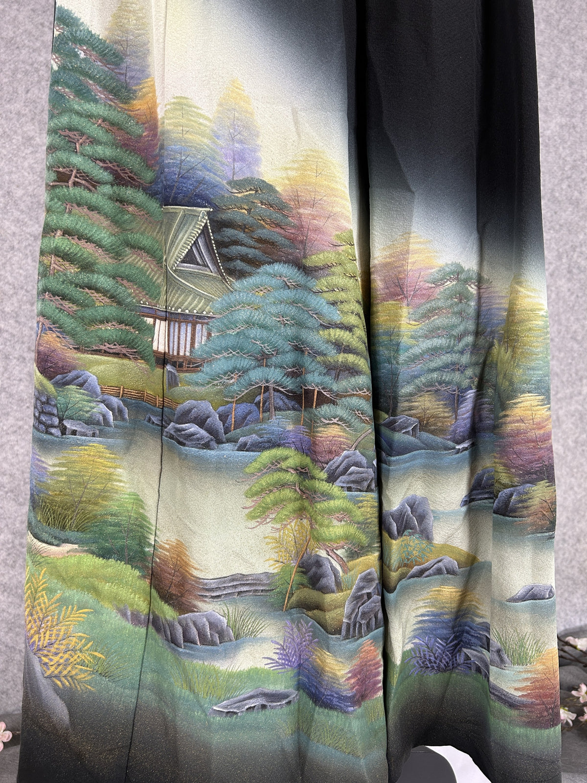 Black upcycled kimono palazzo pants, detail of teal pine trees, house and stream on the hem