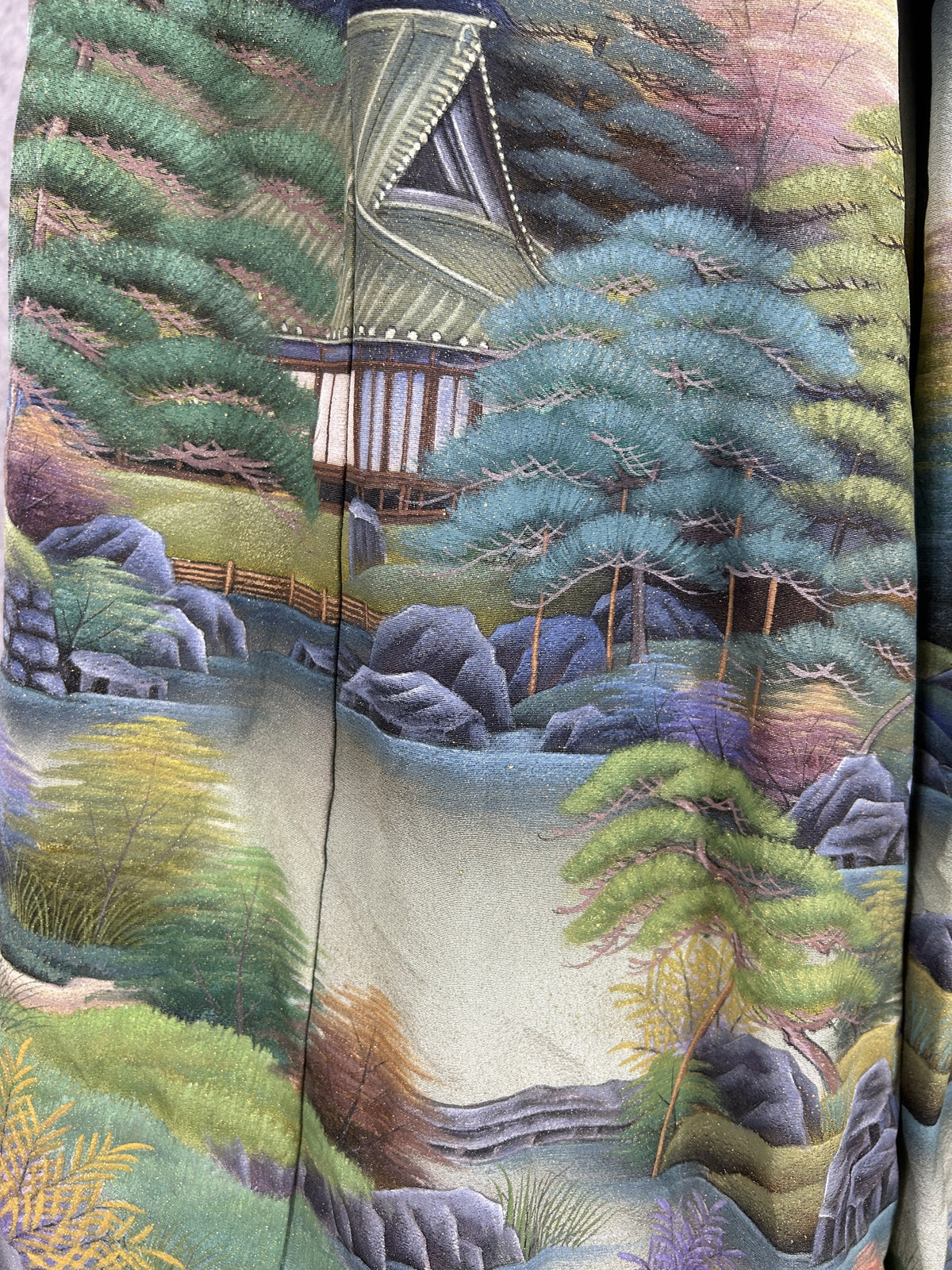 Black upcycled kimono palazzo pants, close-up of the thatched house, pines and rocks