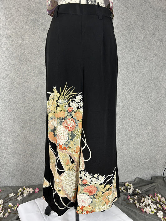 Black upcycled tomesode kimono wide leg pants with peonies, plum blossoms and white cords, front view