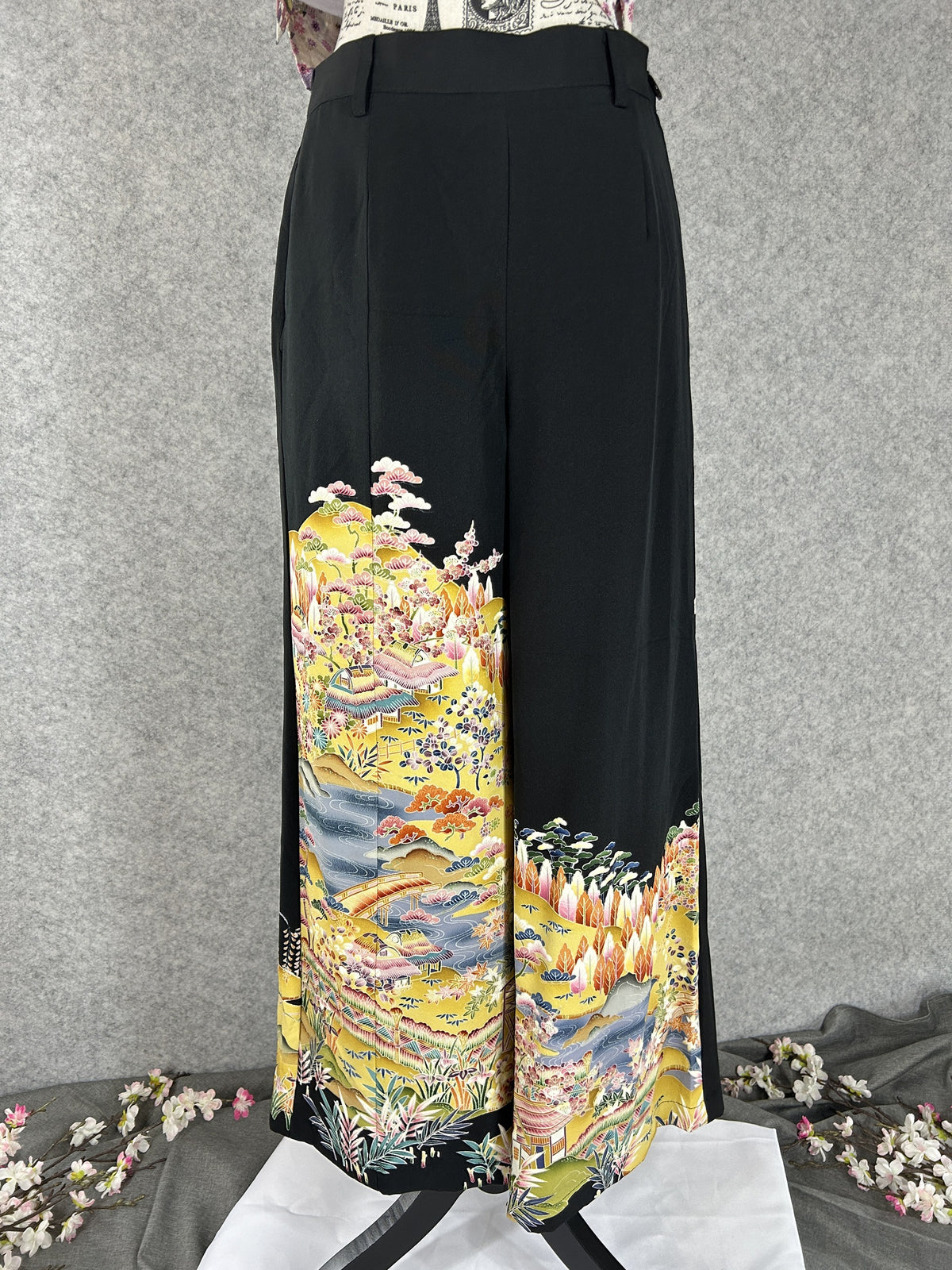 Black upcycled tomesode kimono wide leg pants with a golden village landscape, front view