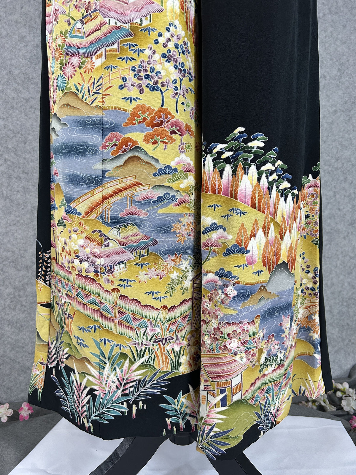 Black upcycled tomesode kimono wide leg pants with a golden village landscape, close-up of the houses and bridge