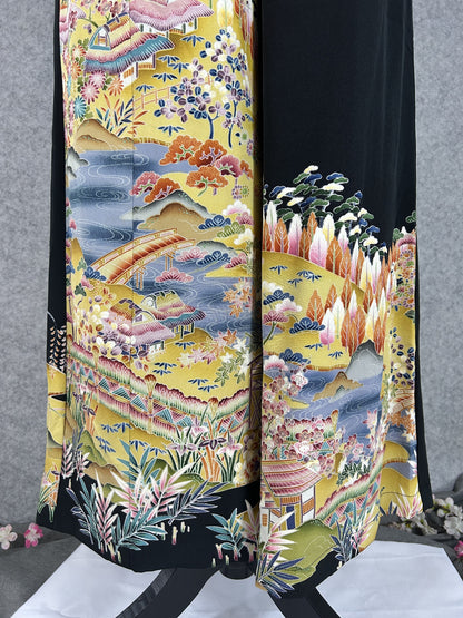 Black upcycled tomesode kimono wide leg pants with a golden village landscape, close-up of the houses and bridge