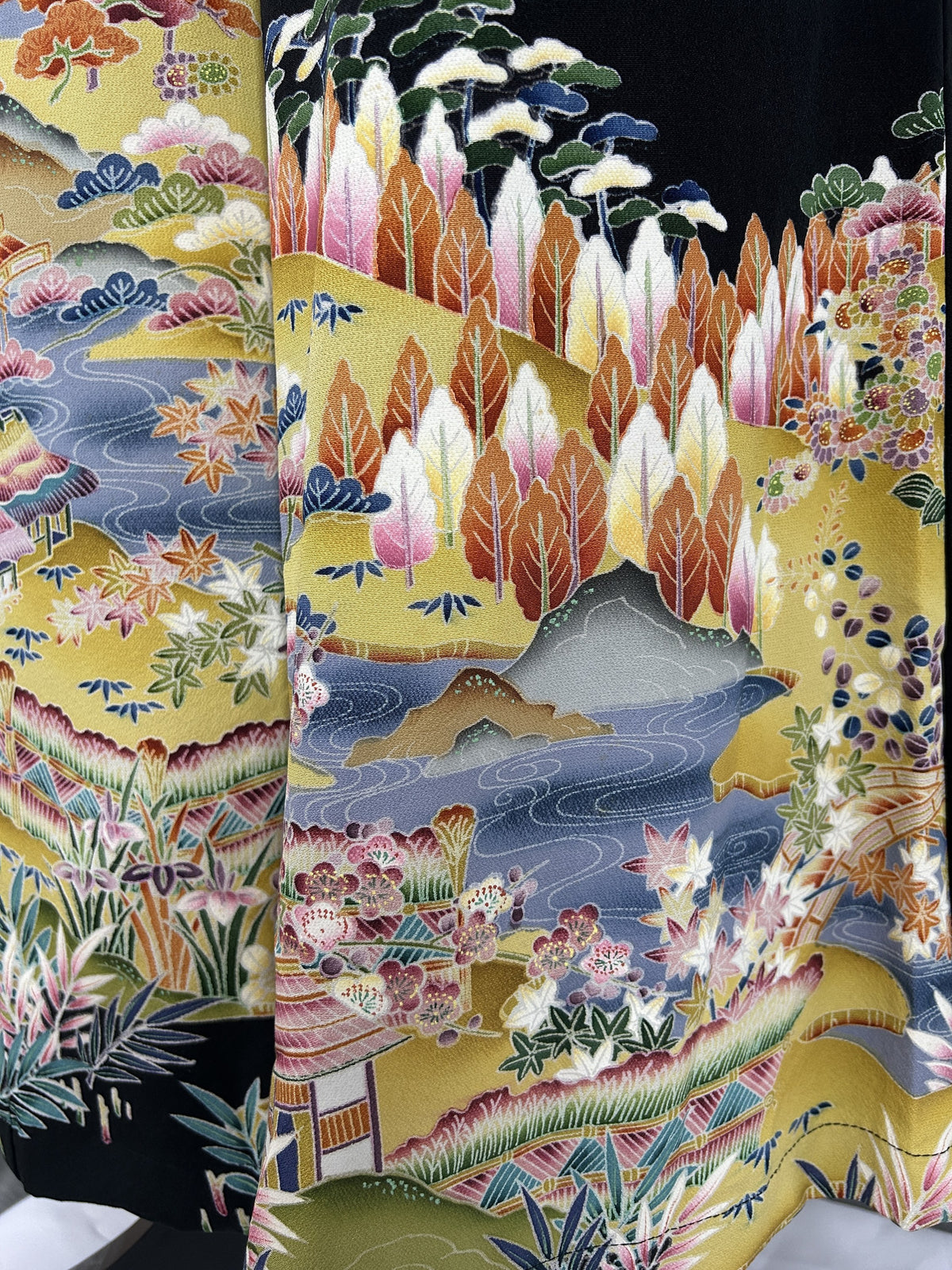 Black upcycled tomesode kimono wide leg pants with a golden village landscape, close-up of the trees and river
