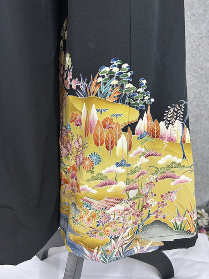 Black upcycled tomesode kimono wide leg pants with a golden village landscape, detail of the landscape at the back hem