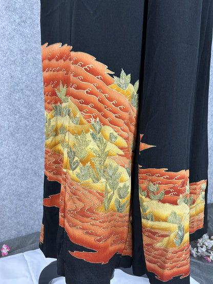 Black upcycled tomesode kimono wide leg pants with orange and gold waves, detail of the orange waves on the left leg