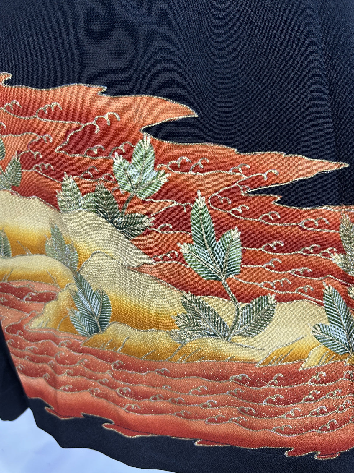 Black upcycled tomesode kimono wide leg pants with orange and gold waves, close-up of the waves and pine sprigs