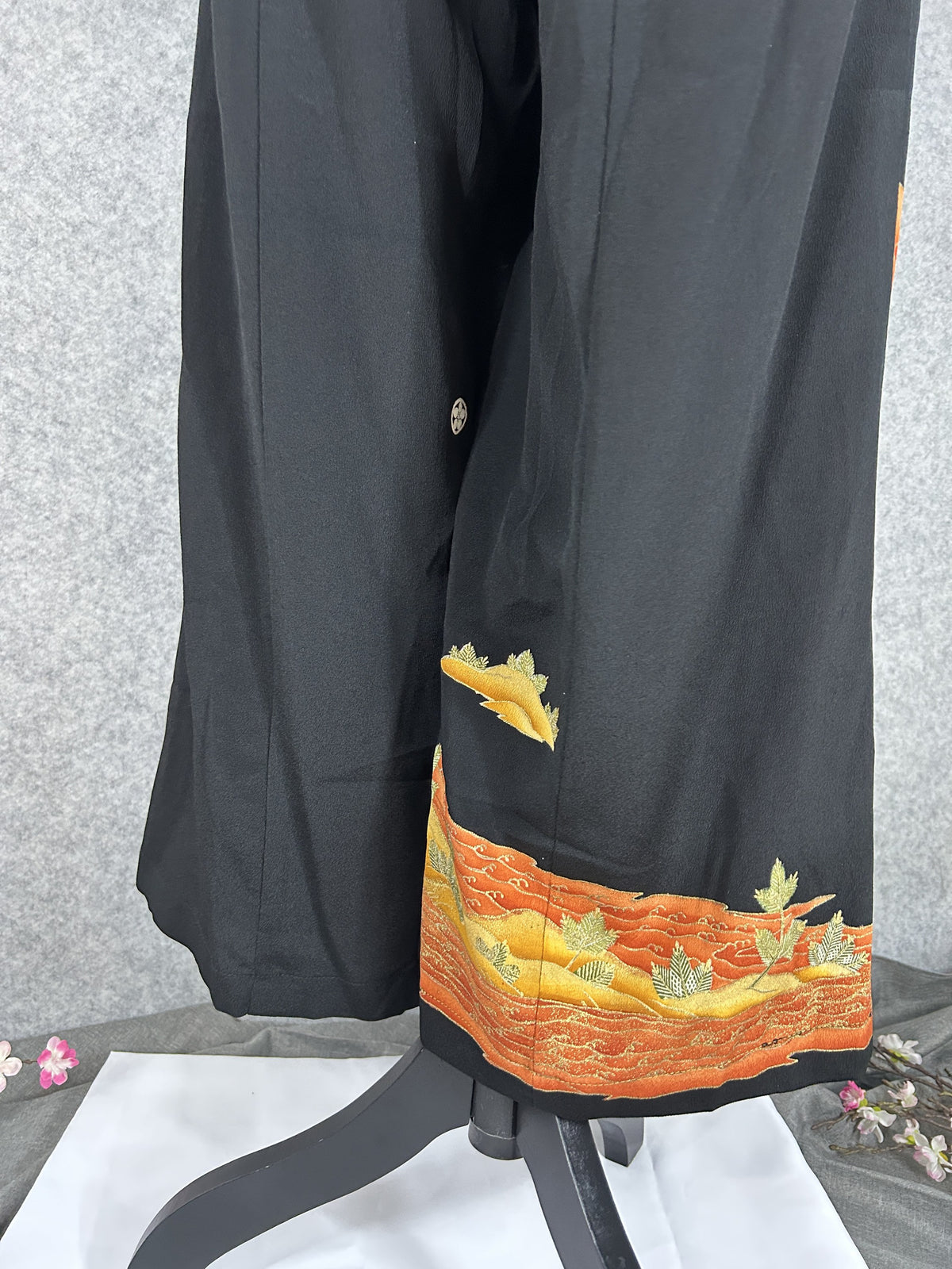 Black upcycled tomesode kimono wide leg pants with orange and gold waves, back view